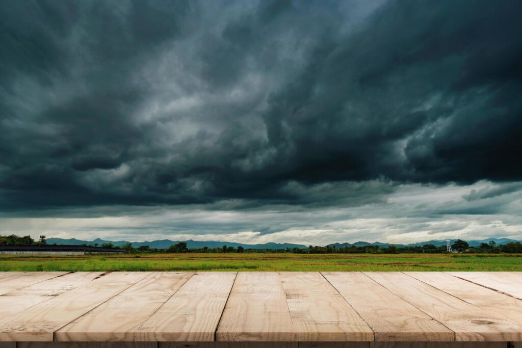Natural scenic beautiful field storm clouds and Empty wood table for product display and montage. Stock Free