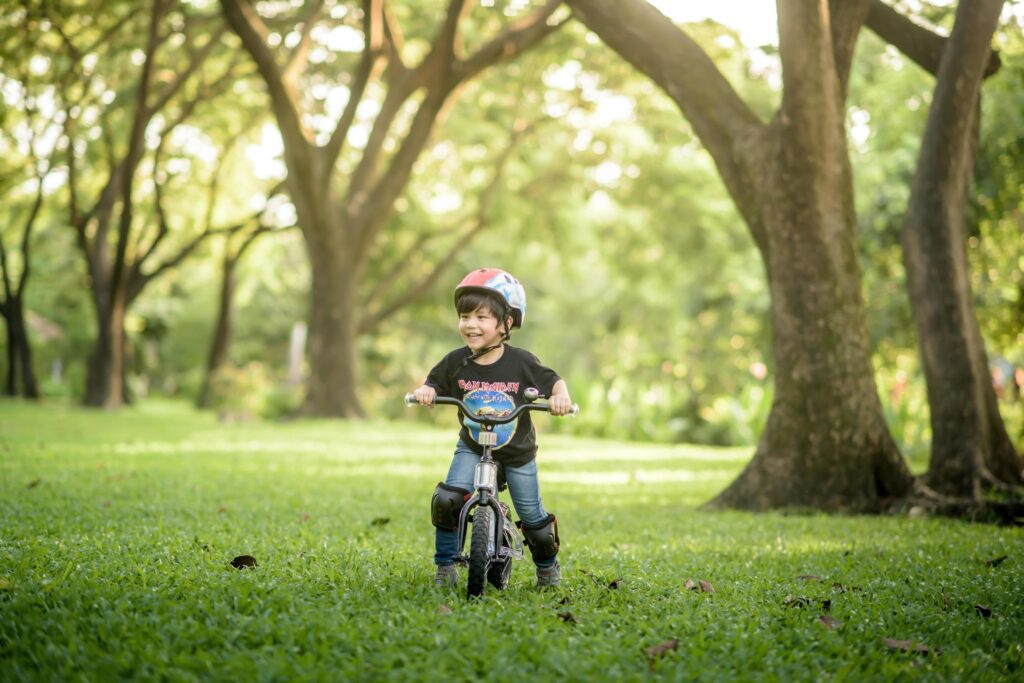 Bangkok Thailand – Oct 09, 2016 happy cheerful child boy riding a bike in Park in the nature Stock Free