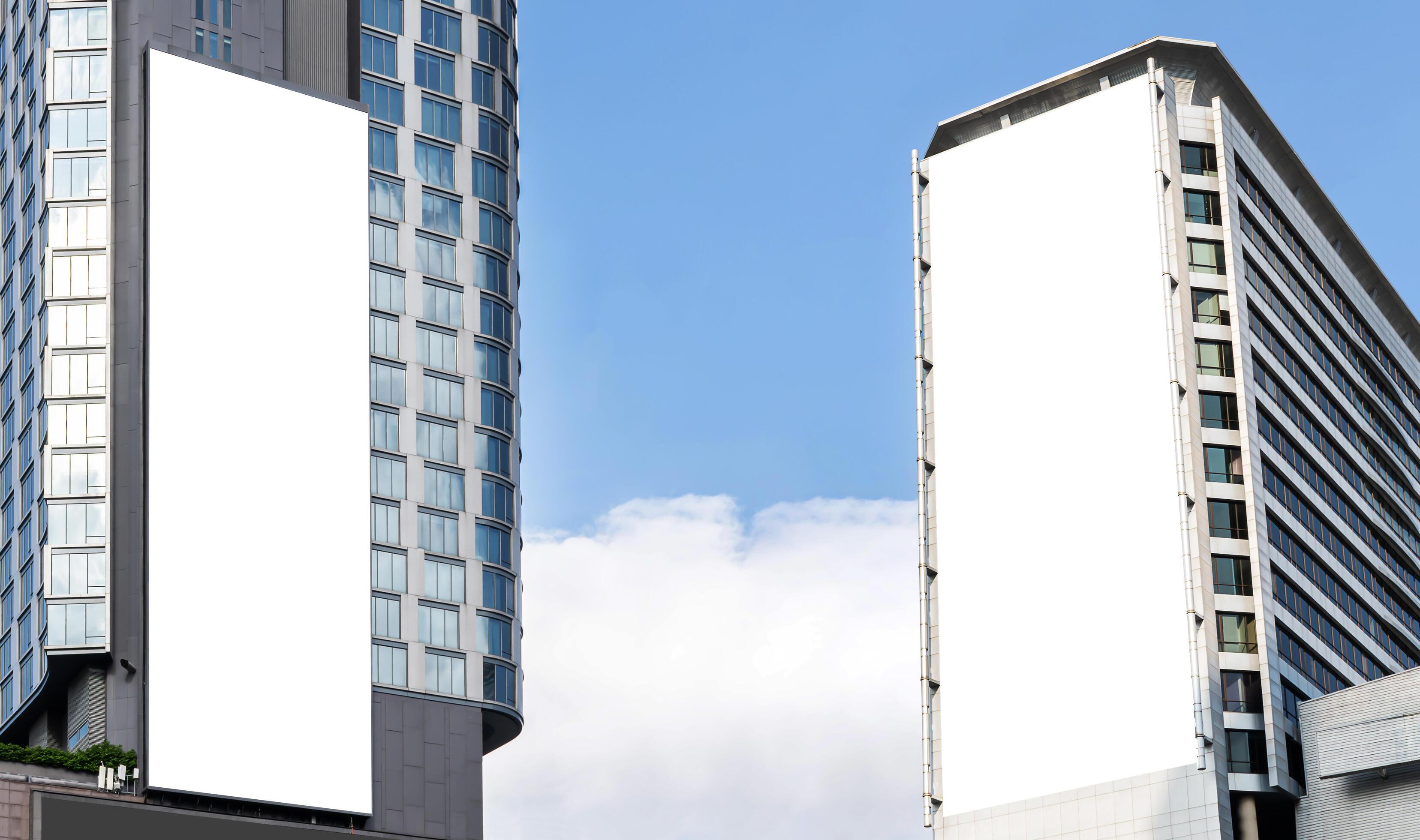 Two outdoor vertical billboard on building with blue sky background Stock Free