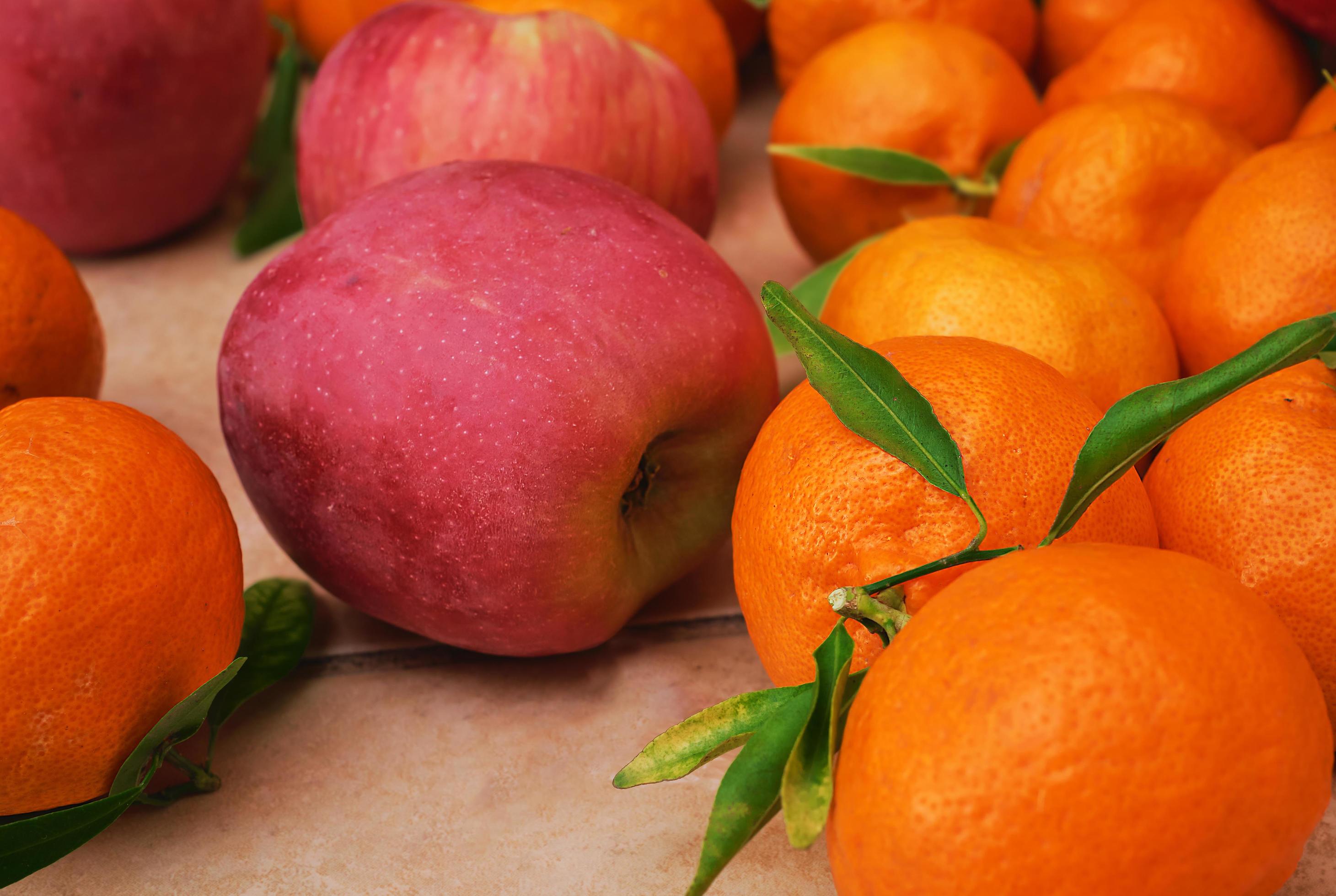 Ripe fruits close up. Selective focus. Fruit delivery from farmers market, healthy food. Citrus fruits and apples on the table Stock Free