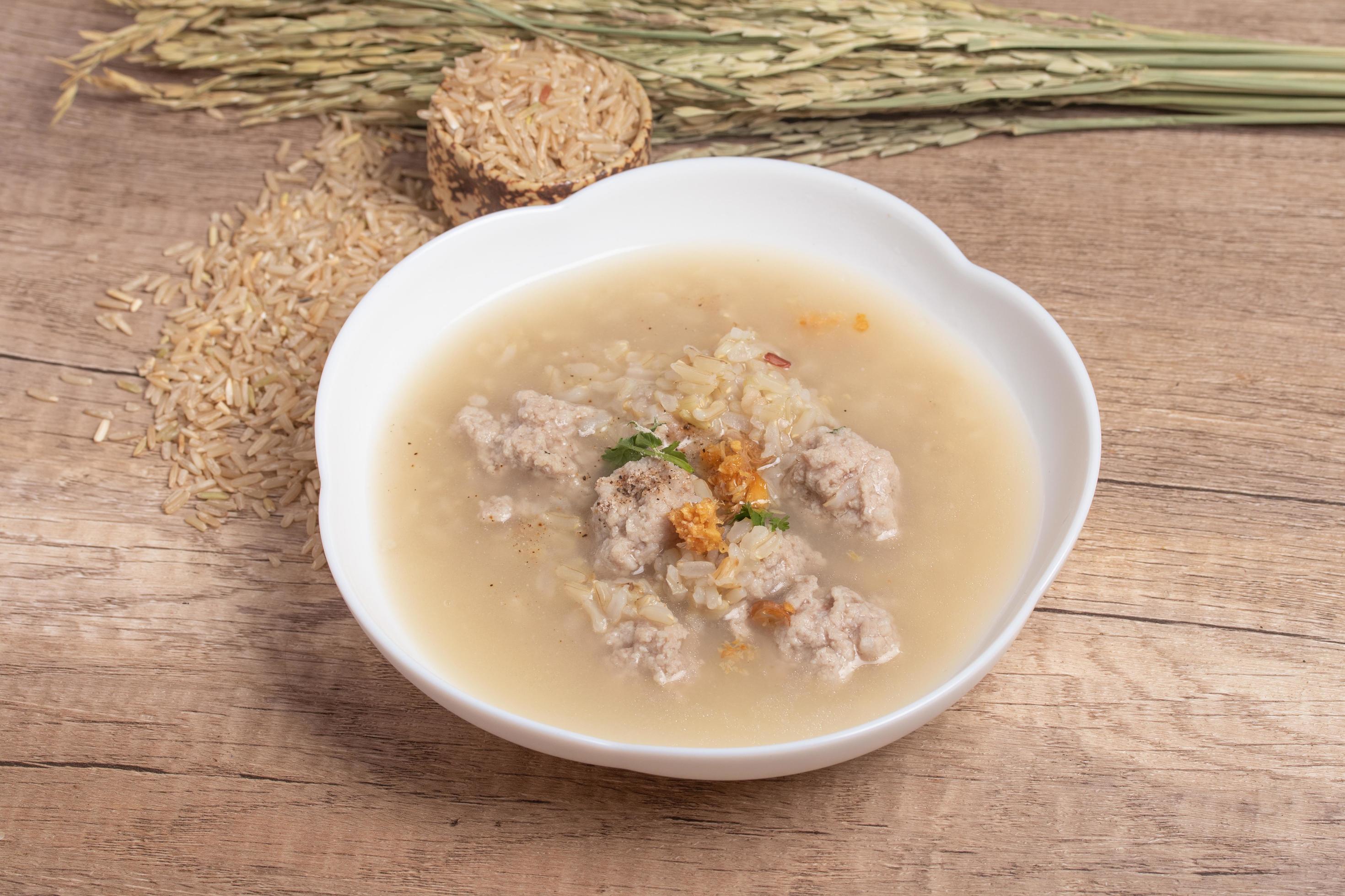 Jasmine brown rice porridge with pork on wooden background.Healthy food copy space Stock Free