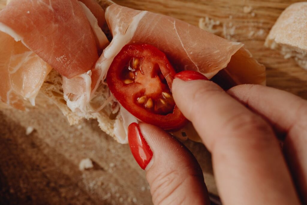 Woman making bruschetta with healthy ingredients Stock Free