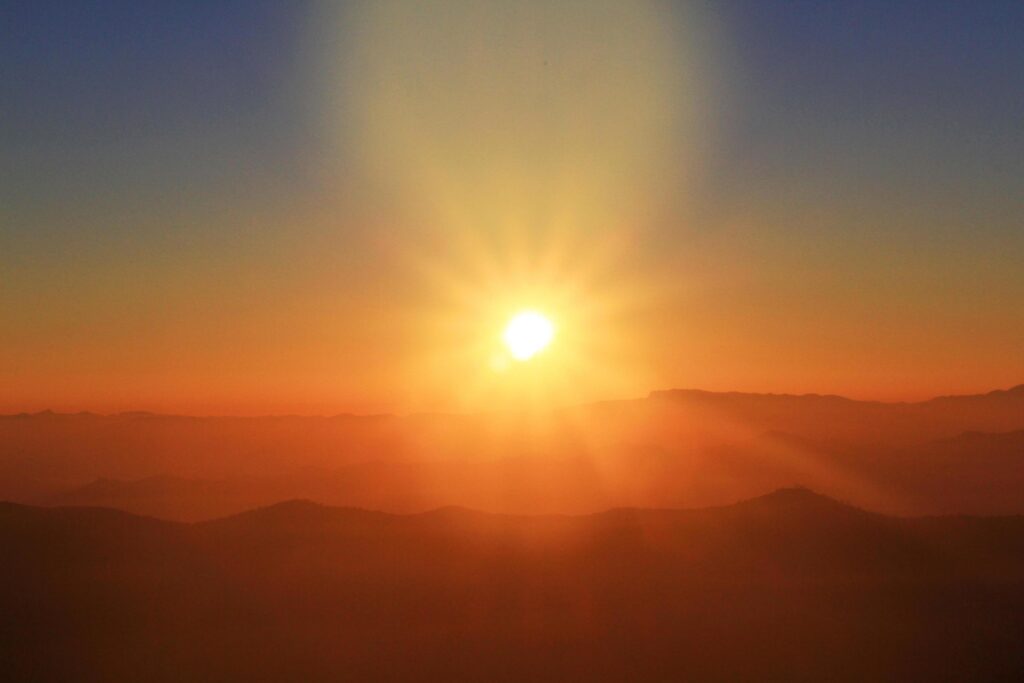 Beautiful golden natural sunlight and twiligh of sunrise shining to in the mist on valley of mountain in Thailand Stock Free