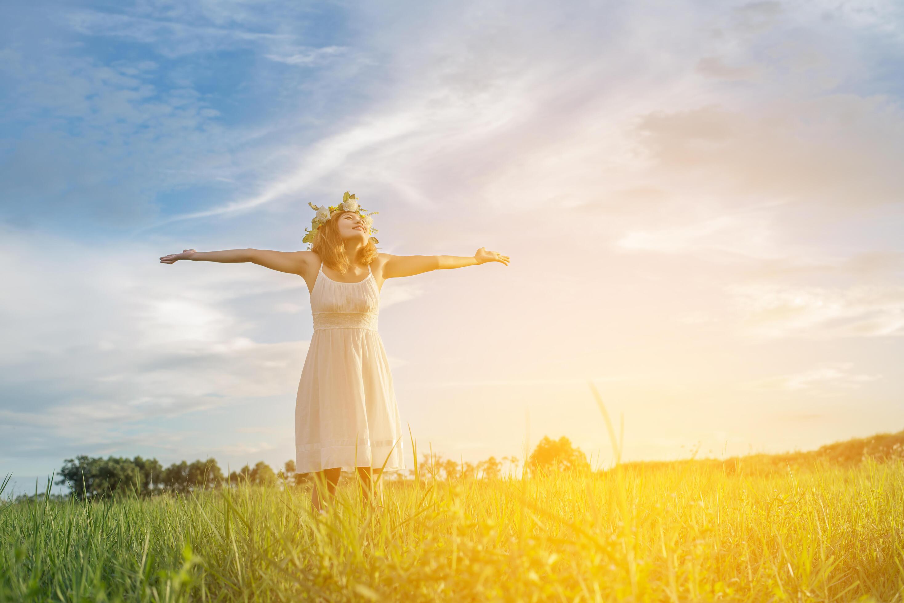 Freedom concept Young beautiful woman enjoying with fresh air and nature at meadows. Stock Free