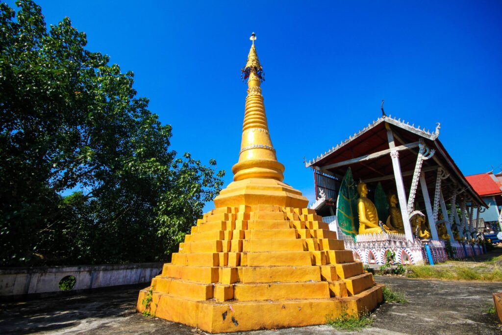 Golden pagoda detail is Mon architectural style at temple located in Kanchanaburi Province, Thailand. Stock Free