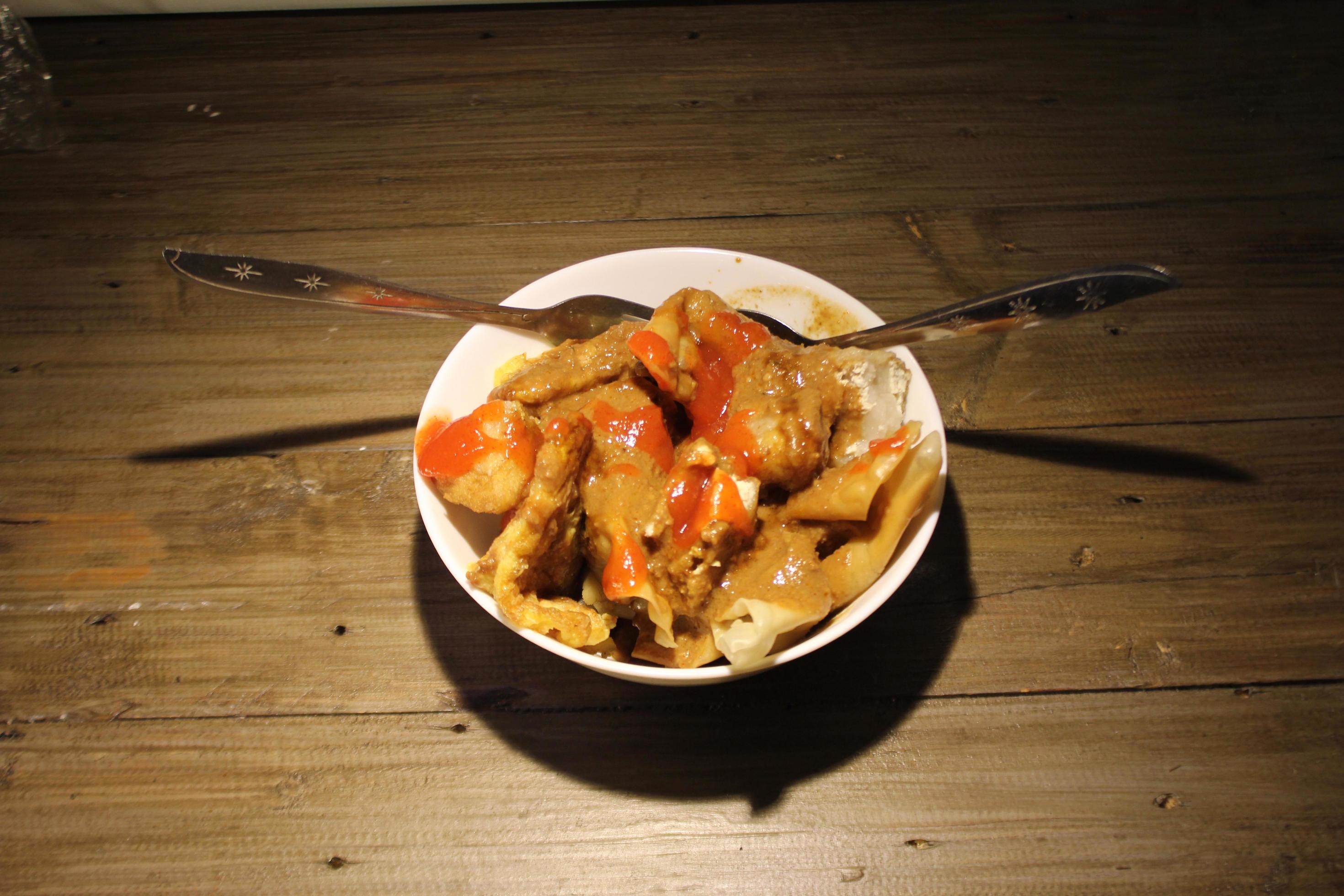 fried batagor on a white bowl. batagor is an Indonesian snack food, usually enjoyed with the addition of peanut sauce, soy sauce and chili sauce. Stock Free