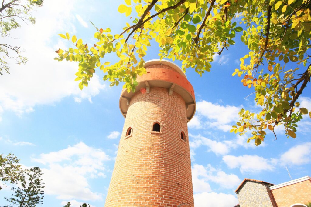 Beautiful brick stone tower is architecture roman stytle landmark in the garden and park at Thailand. Stock Free