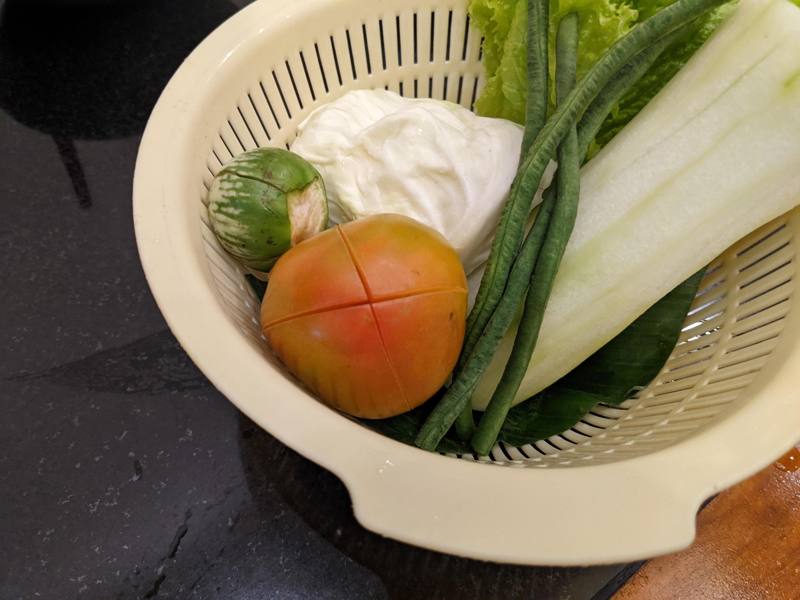 Close up photo of salad on the white basket, tomato, eggplant and cabbage. The photo is suitable to use for vegan food background, poster and food content. Stock Free