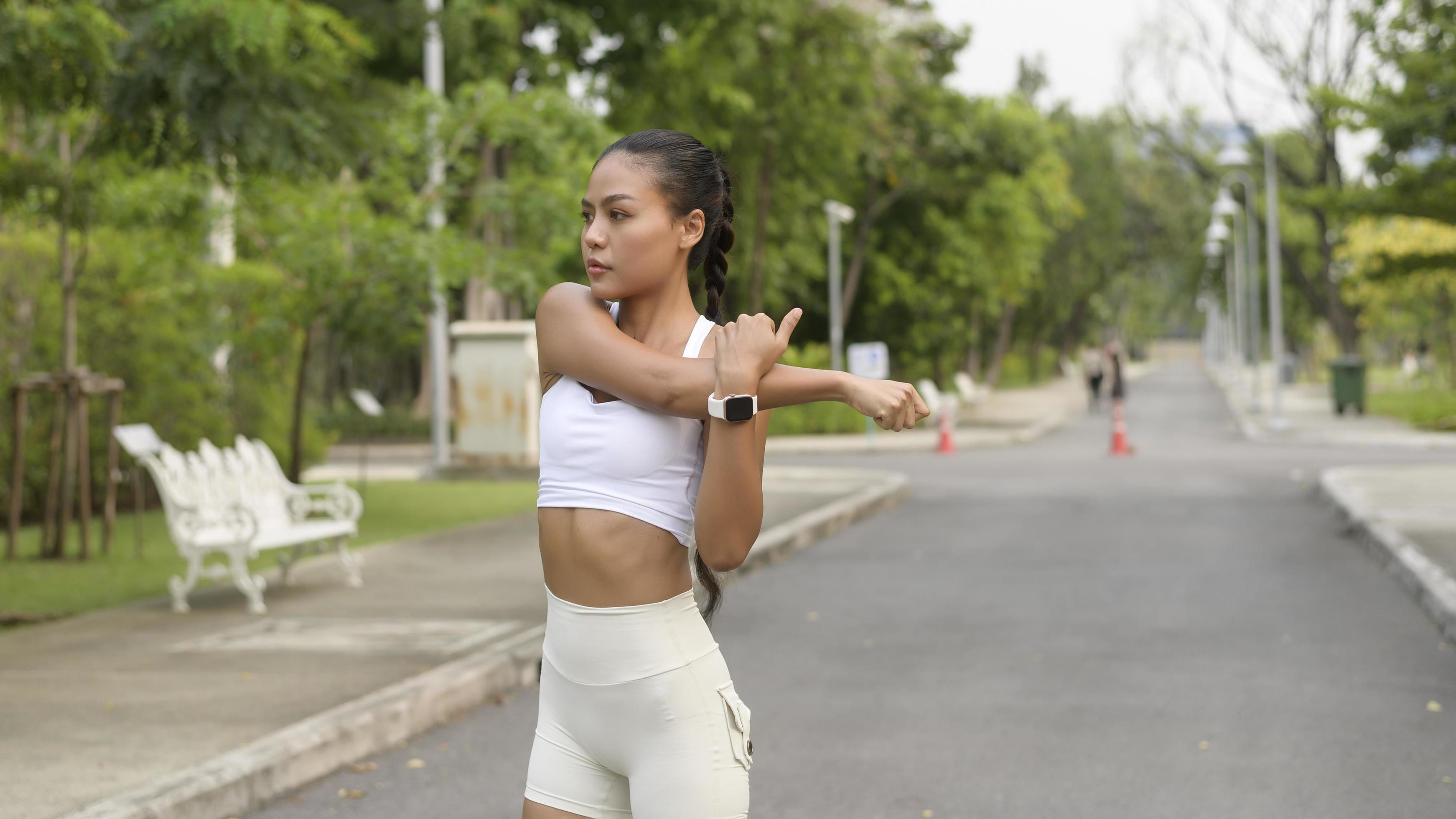 Young fitness woman in sportswear exercising in city park, Healthy and Lifestyles. Stock Free