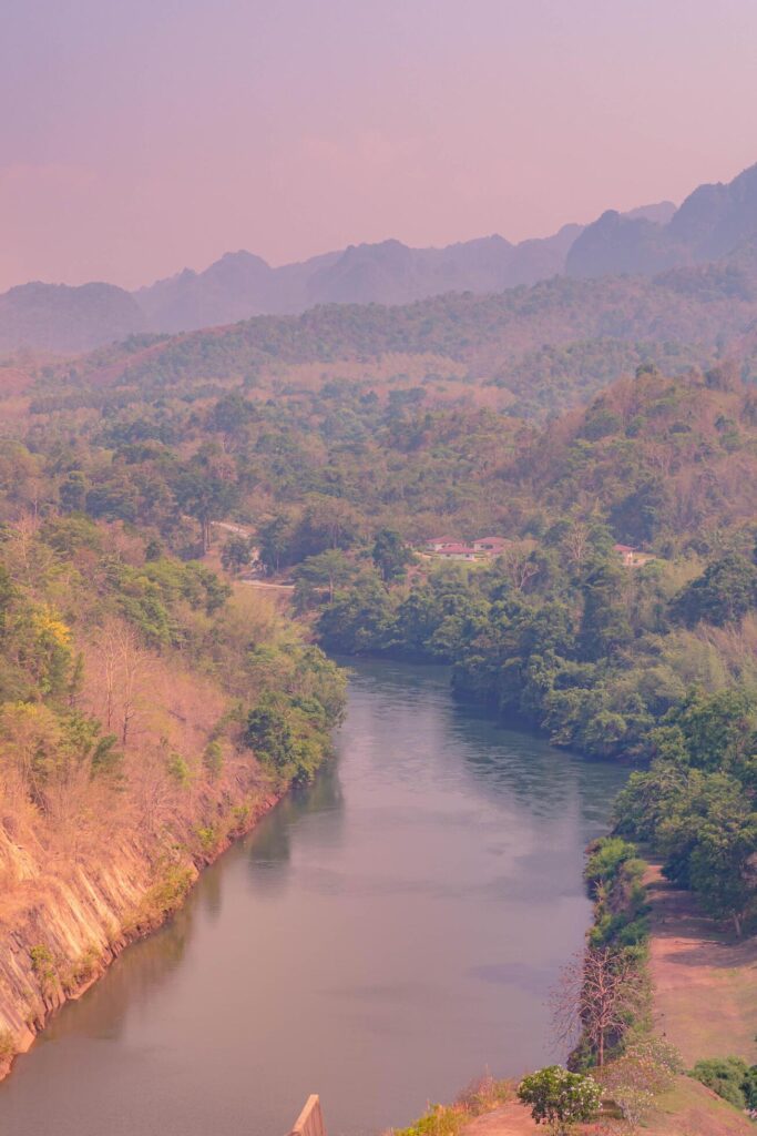 An aerial view of the dam-caused canal in Thailand’s national park, with a mountain the background. Bird eye view. Stock Free