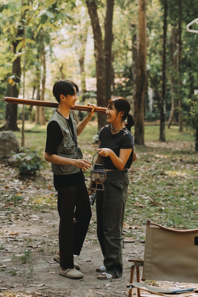 Asian couple sweet in tent inside on they camping trip, traveller relax and sleep togather in out door and camping trip Stock Free