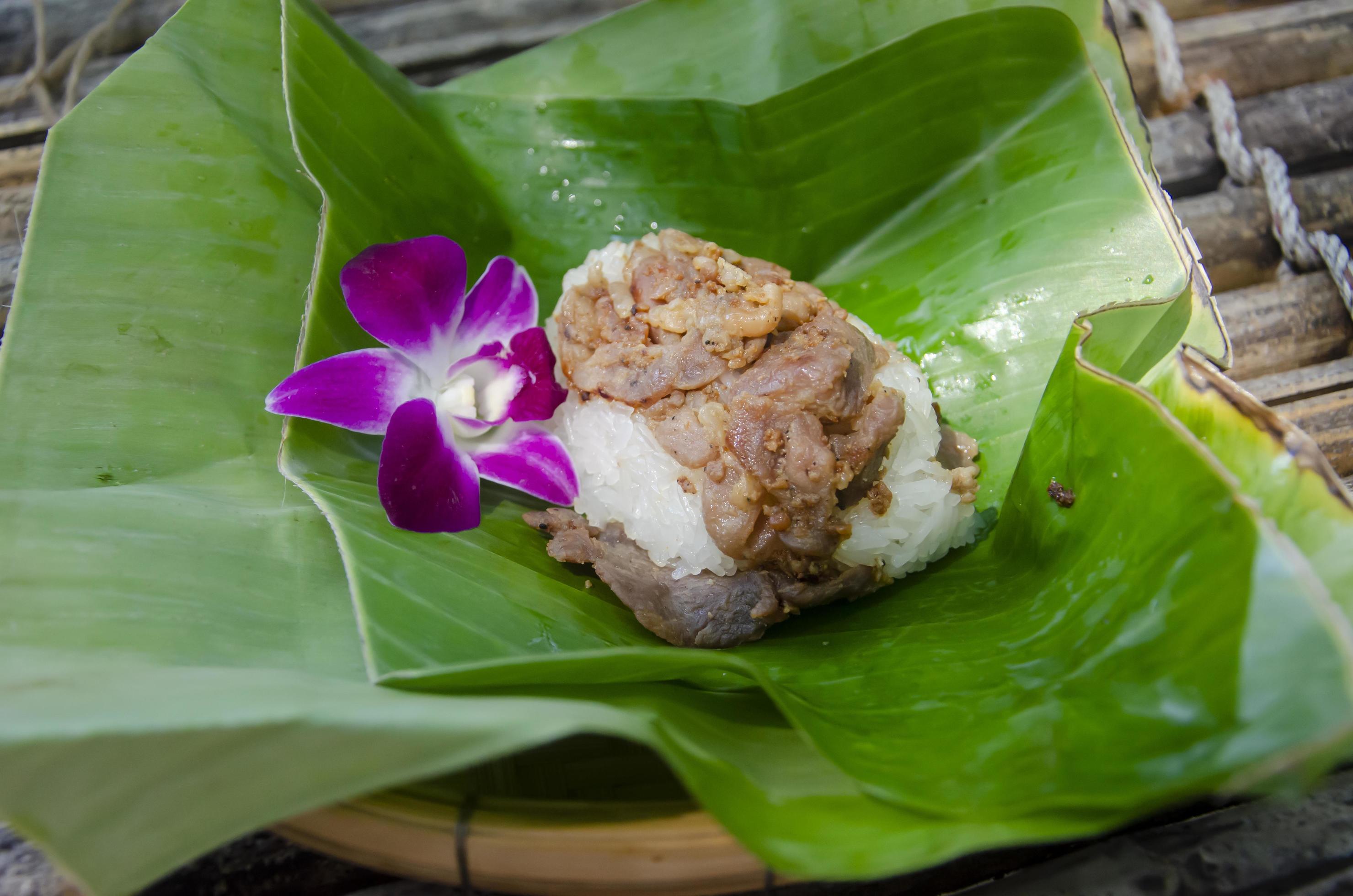 Fried pork with sticky rice on banana leaves, Thai food Stock Free