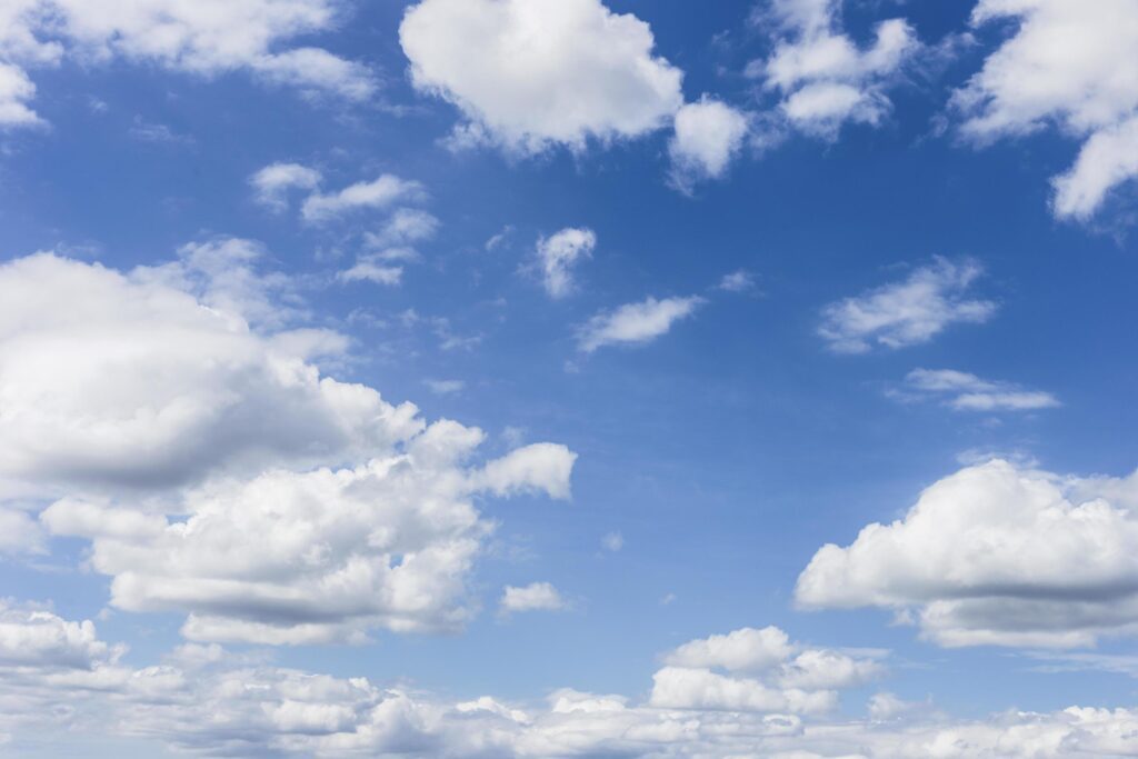 clear blue sky with plain white cloud with space for text background. The vast blue sky and clouds. blue sky background with tiny clouds nature. Stock Free