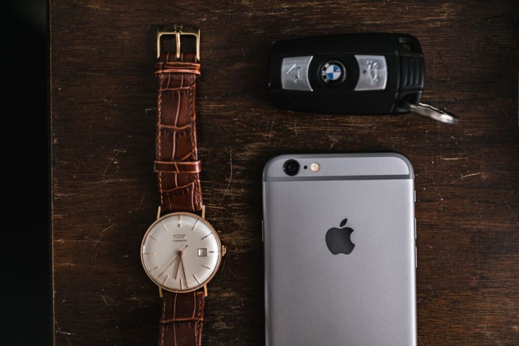 Apple iPhone 6 and Vintage watch on a brown leather wallet Stock Free