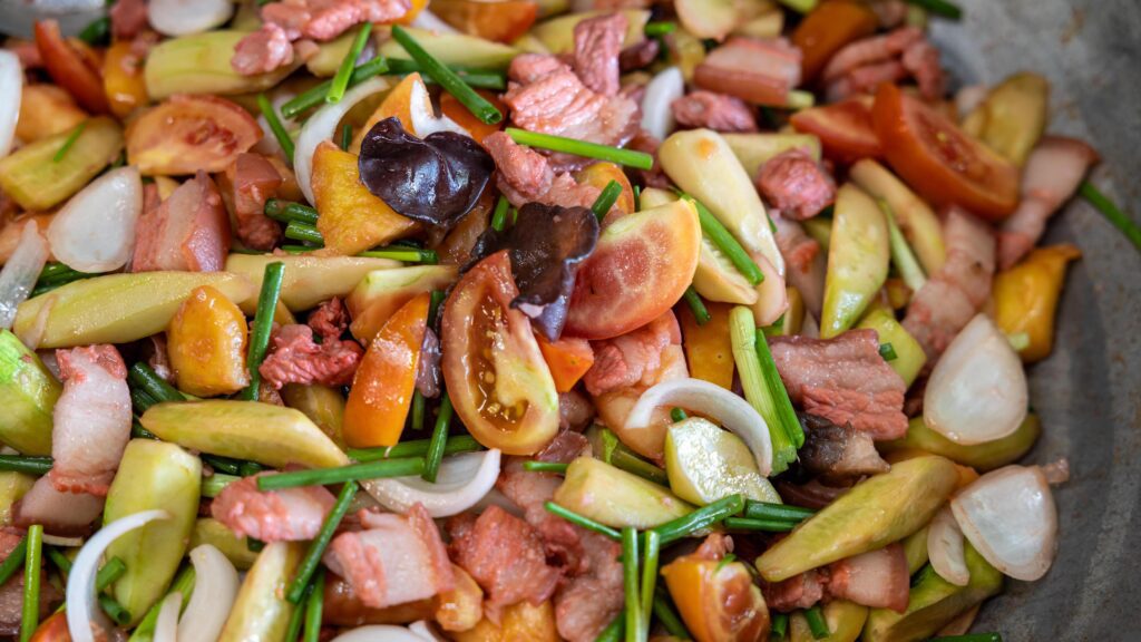 Close-up view of the background of sweet and sour stir-fry, consisting of pork pieces. Stock Free