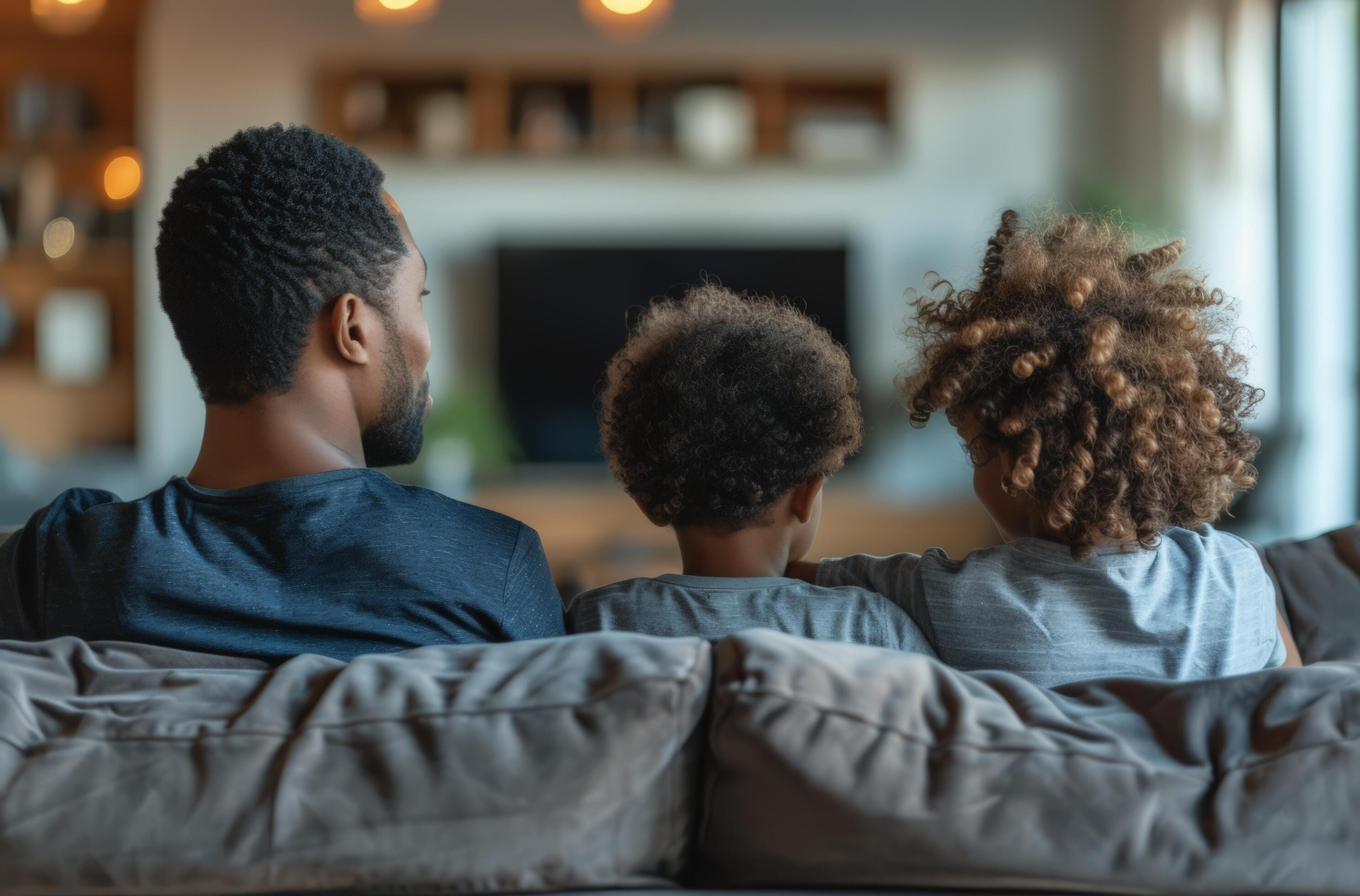 AI generated a family looking at a tv while sitting on the sofa Stock Free