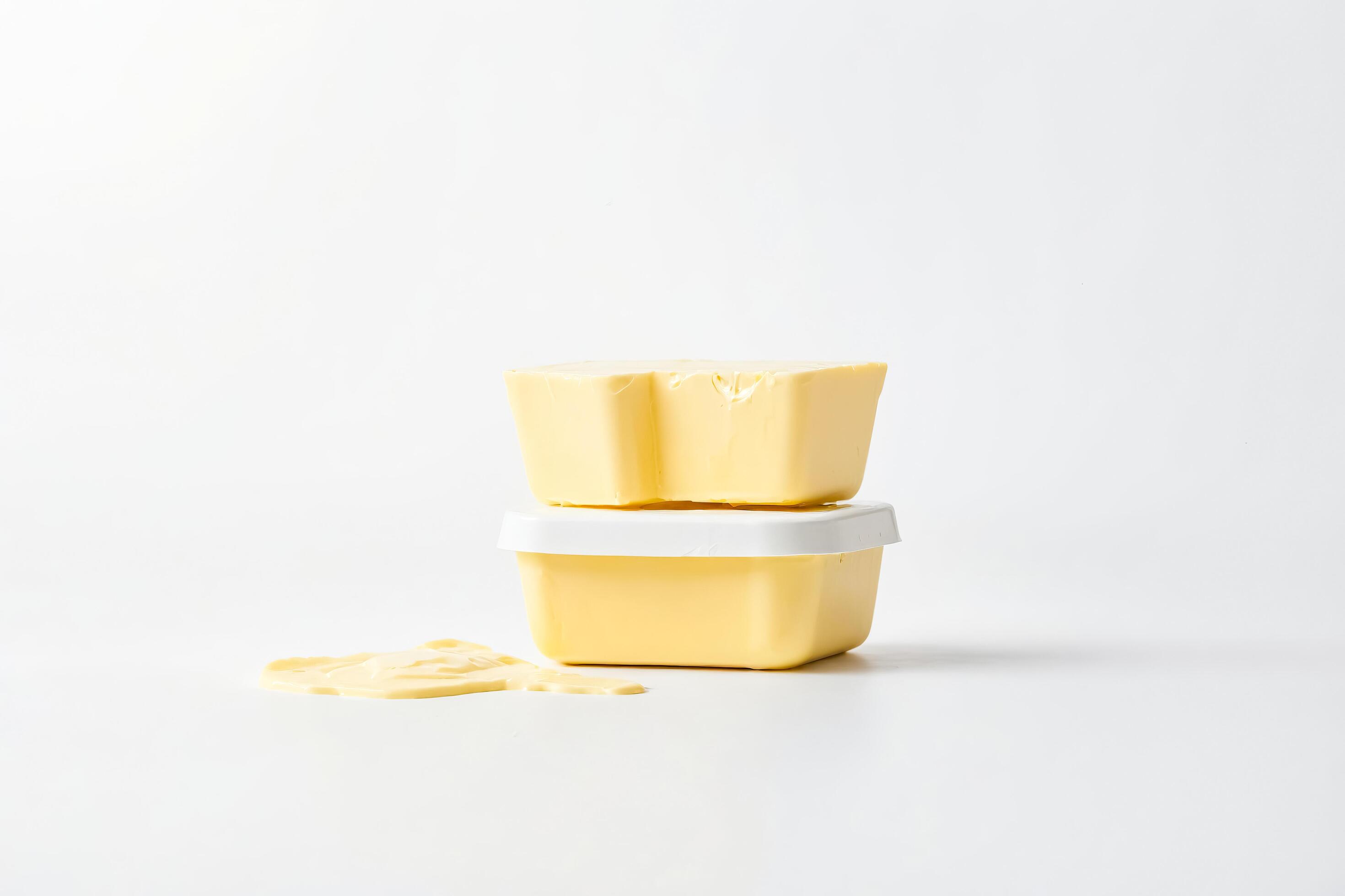 Butter Container with Spilled Butter on White Background Stock Free