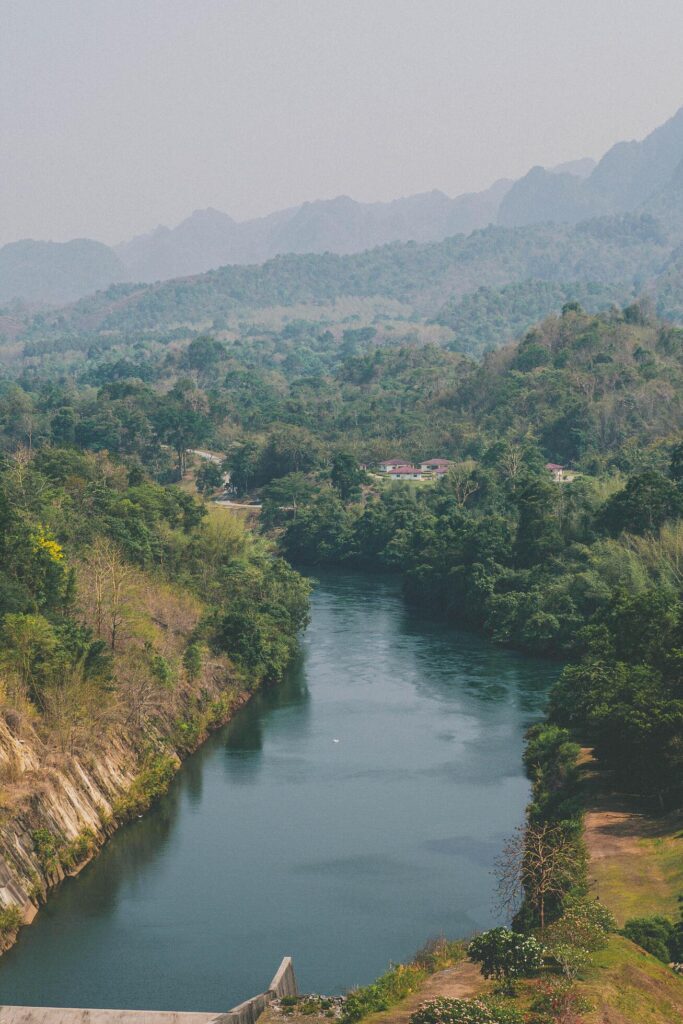 An aerial view of the dam-caused canal in Thailand’s national park, with a mountain the background. Bird eye view. Stock Free