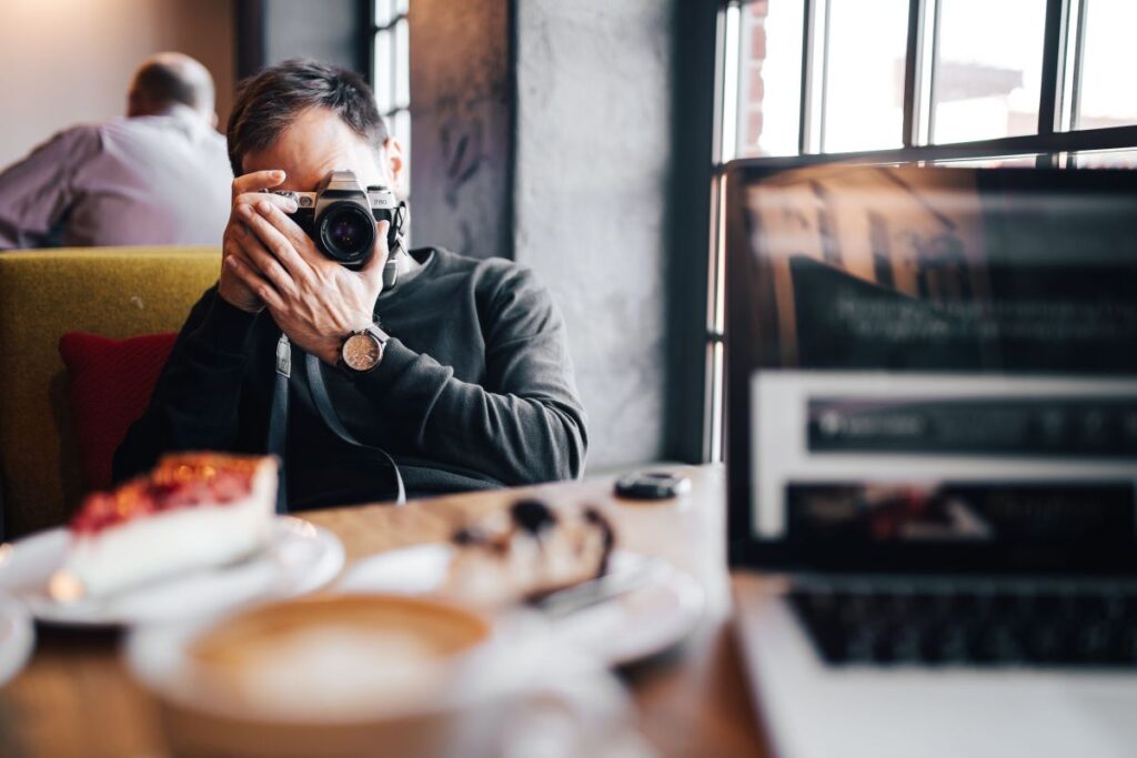 
									Young Elegantly dressed man sititng in a cafe Stock Free