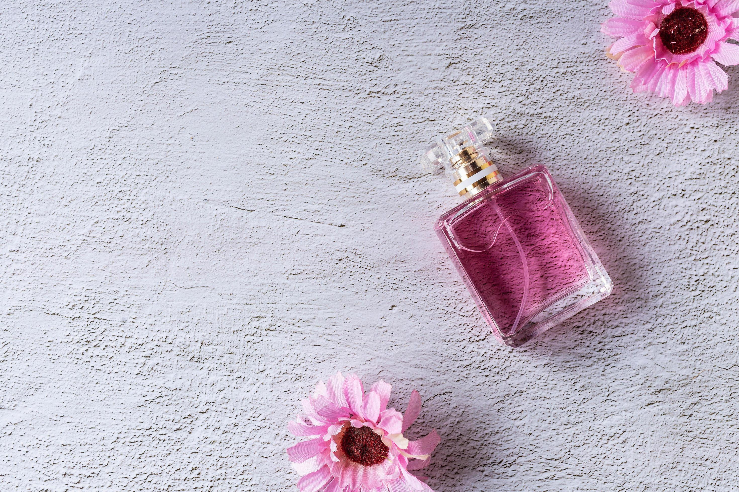 pink perfume bottle with pink flowers Stock Free