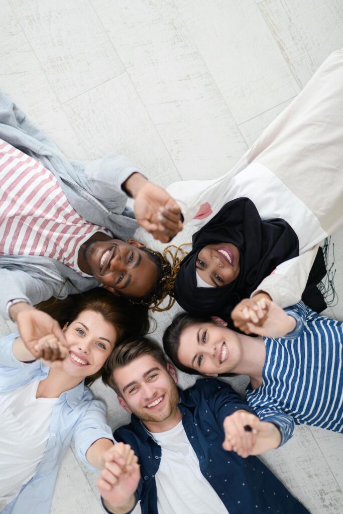 top view of a diverse group of people lying on the floor and symbolizing togetherness Stock Free