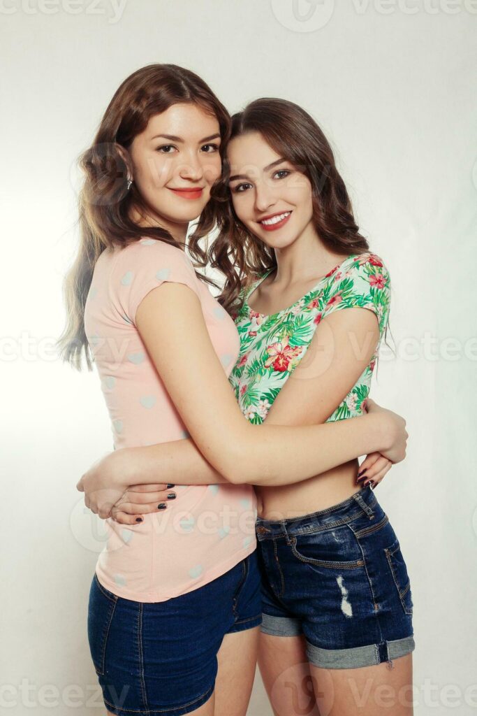 happy smiling pretty teenage girls or friends hugging Pro Photo