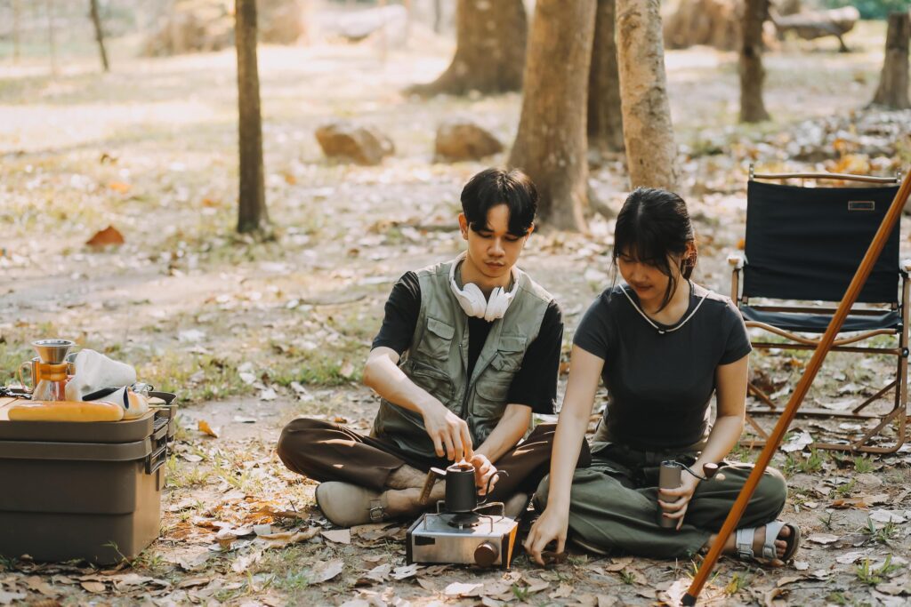 Asian couple sweet in tent inside on they camping trip, traveller relax and sleep togather in out door and camping trip Stock Free