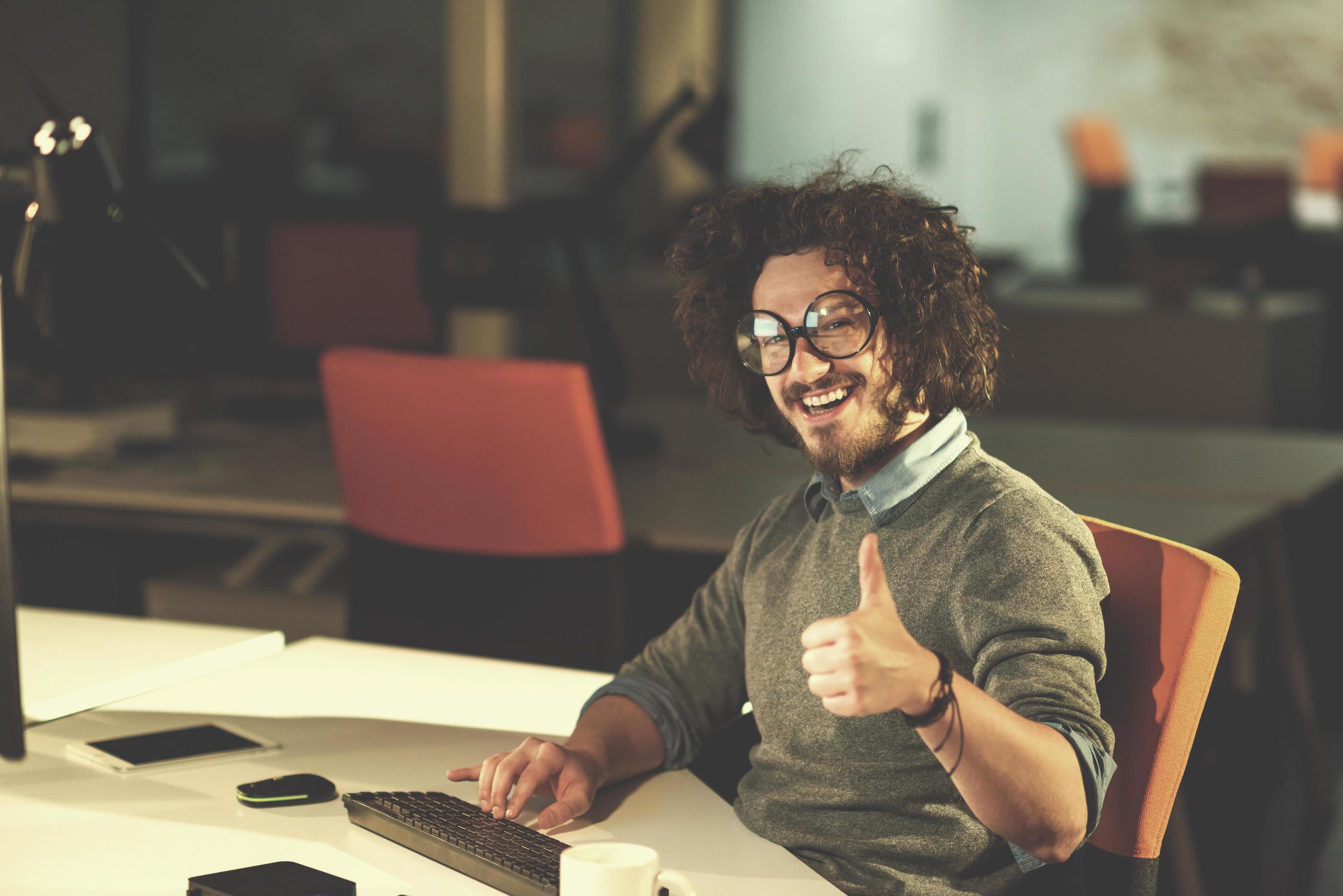 man working on computer in dark startup office Stock Free