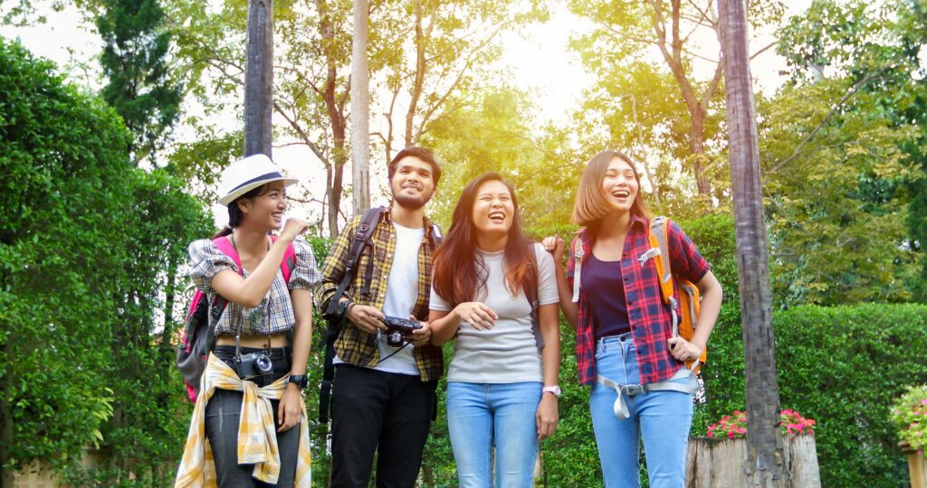 Asian Group of young people with friends backpacks walking together and happy friends are taking photo and selfie ,Relax time on holiday concept travel Stock Free