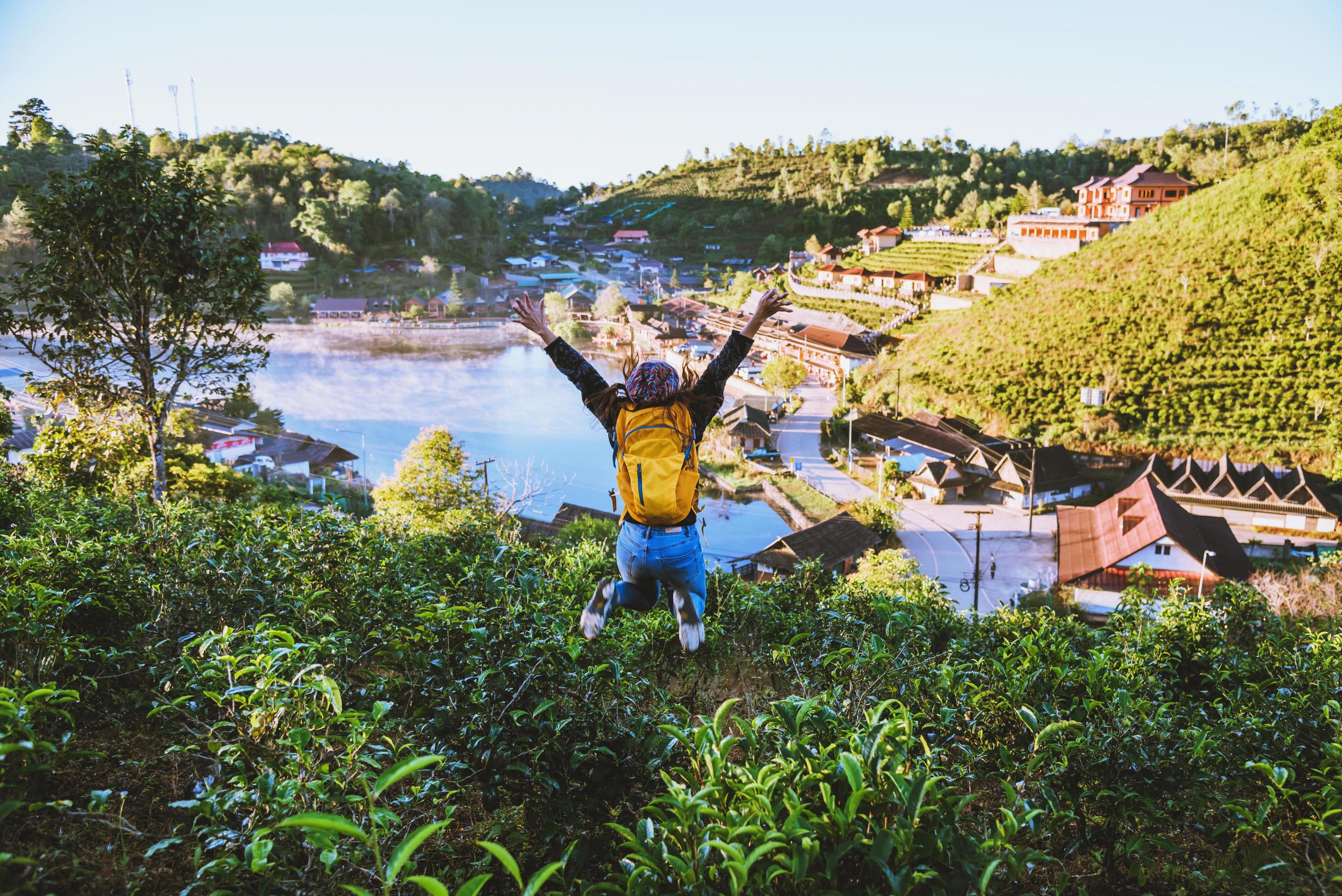 The girl enjoyed and enjoyed his travels. She laughed and jumped in the tea plantation. Travel nature in village countryside. Stock Free