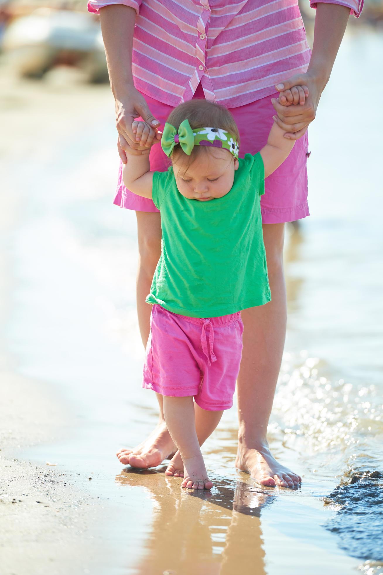 mom and baby on beach have fun Stock Free