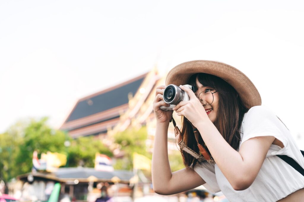 Young asian cute woman traveling in Bangkok and take photo with camera. Stock Free