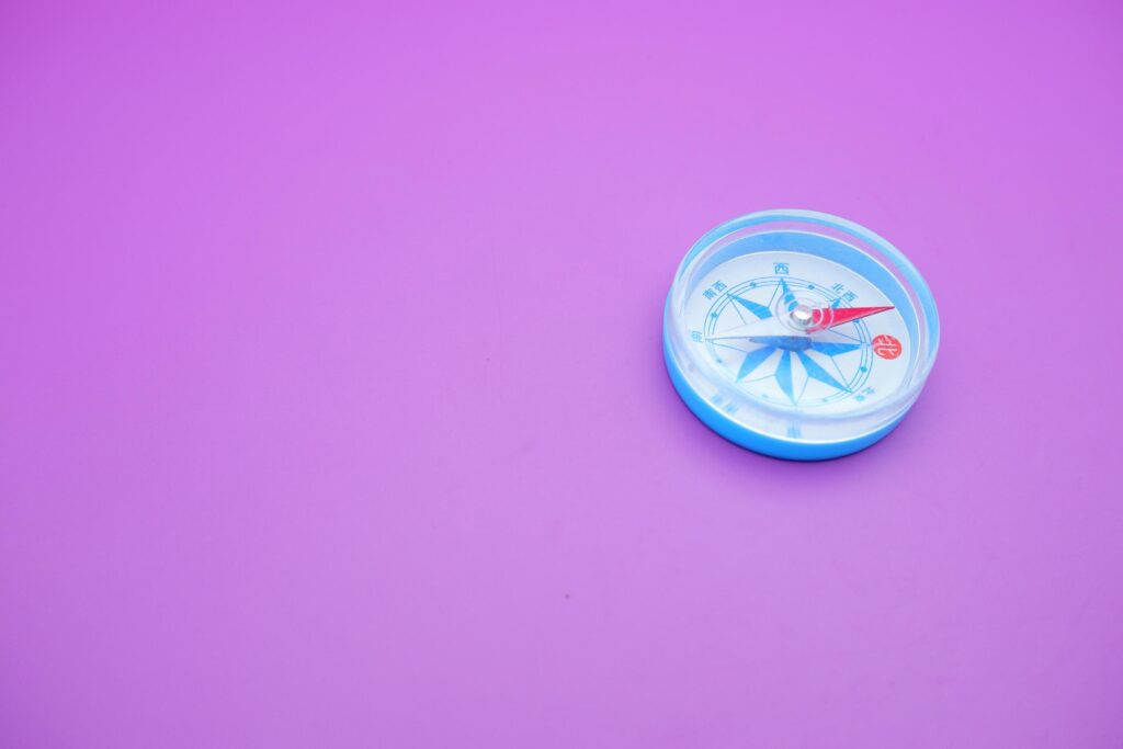 round compass isolated on purple background. Stock Free