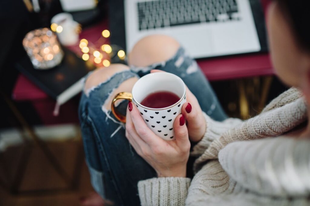 Woman drinking hot tea in her home office Stock Free