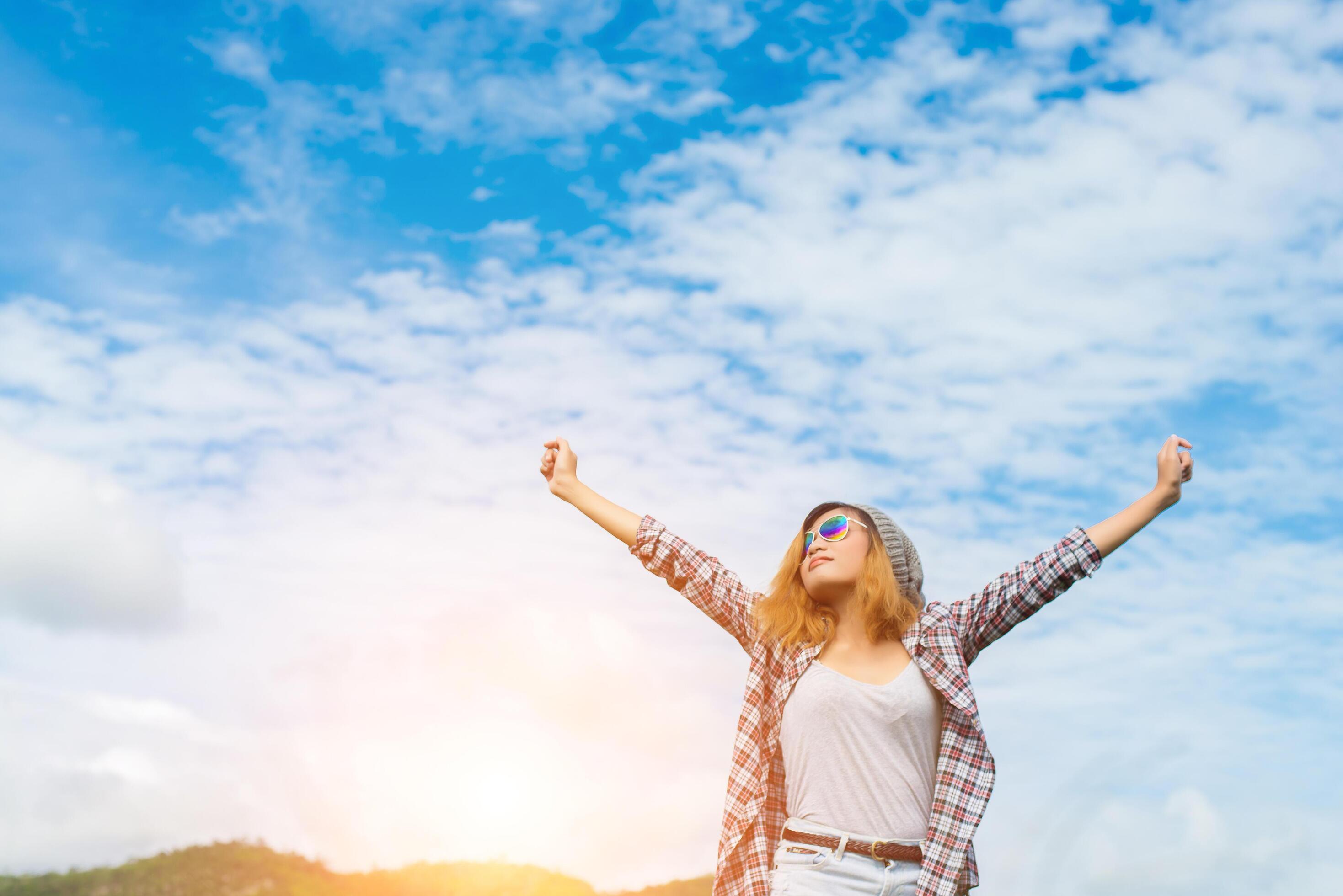 Young beautiful woman enjoying freedom and life in nature behind the mountain. Stock Free