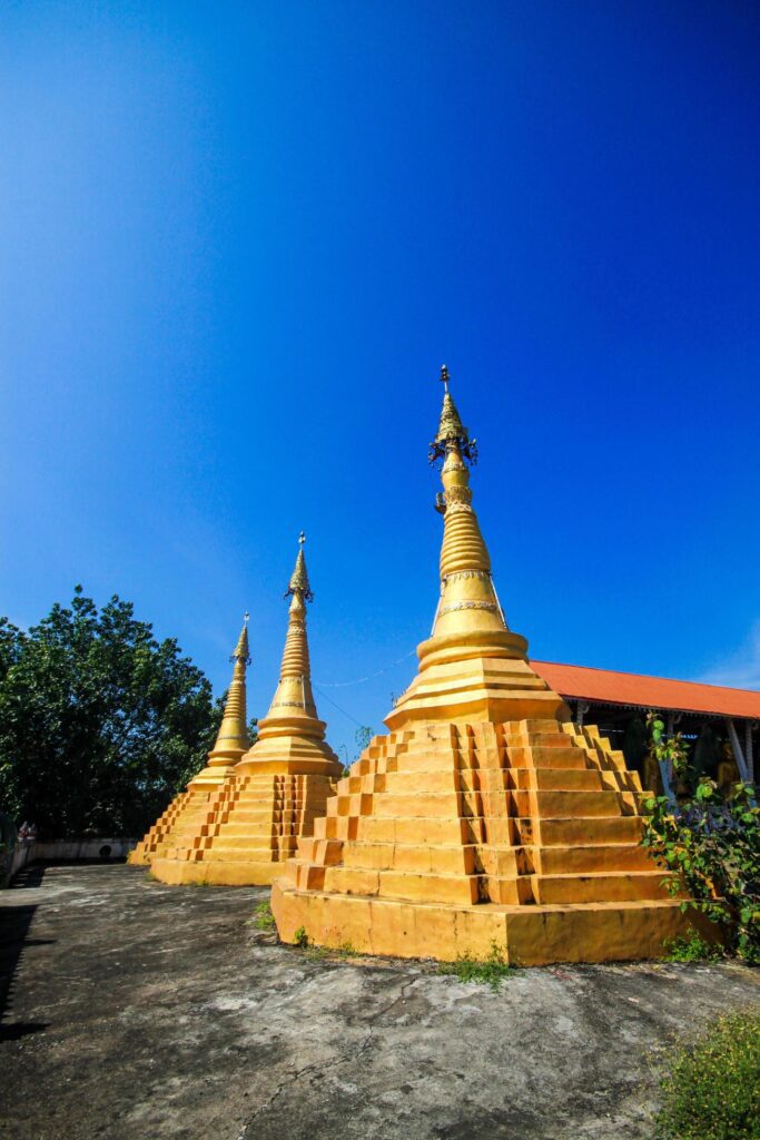 Golden pagoda detail is Mon architectural style at temple located in Kanchanaburi Province, Thailand. Stock Free