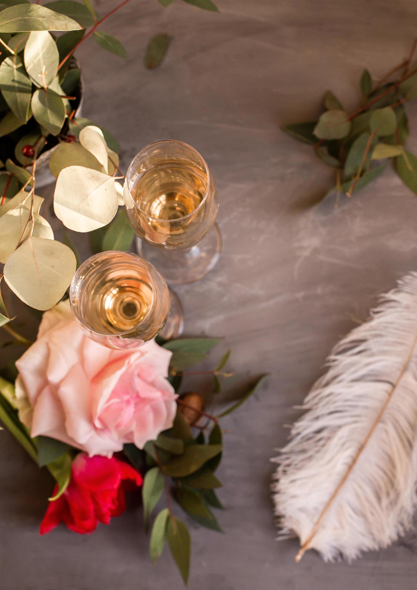 Composition with glasses of vine and flowers on grey concrete background. Stock Free