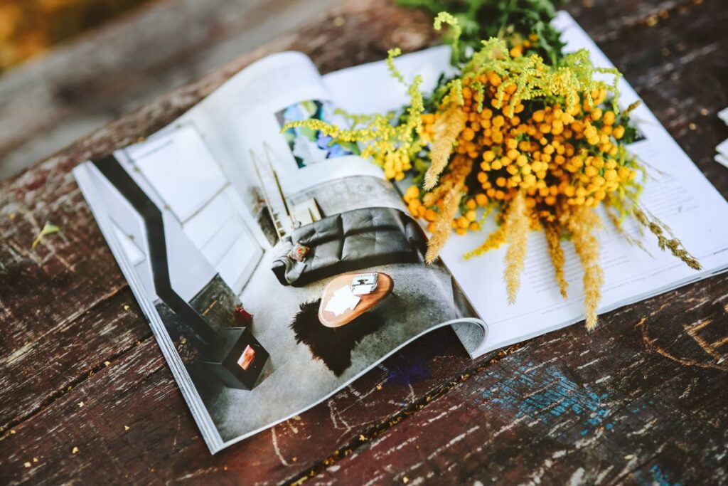 Yellow flowers with miscellaneous items on wooden floor Stock Free