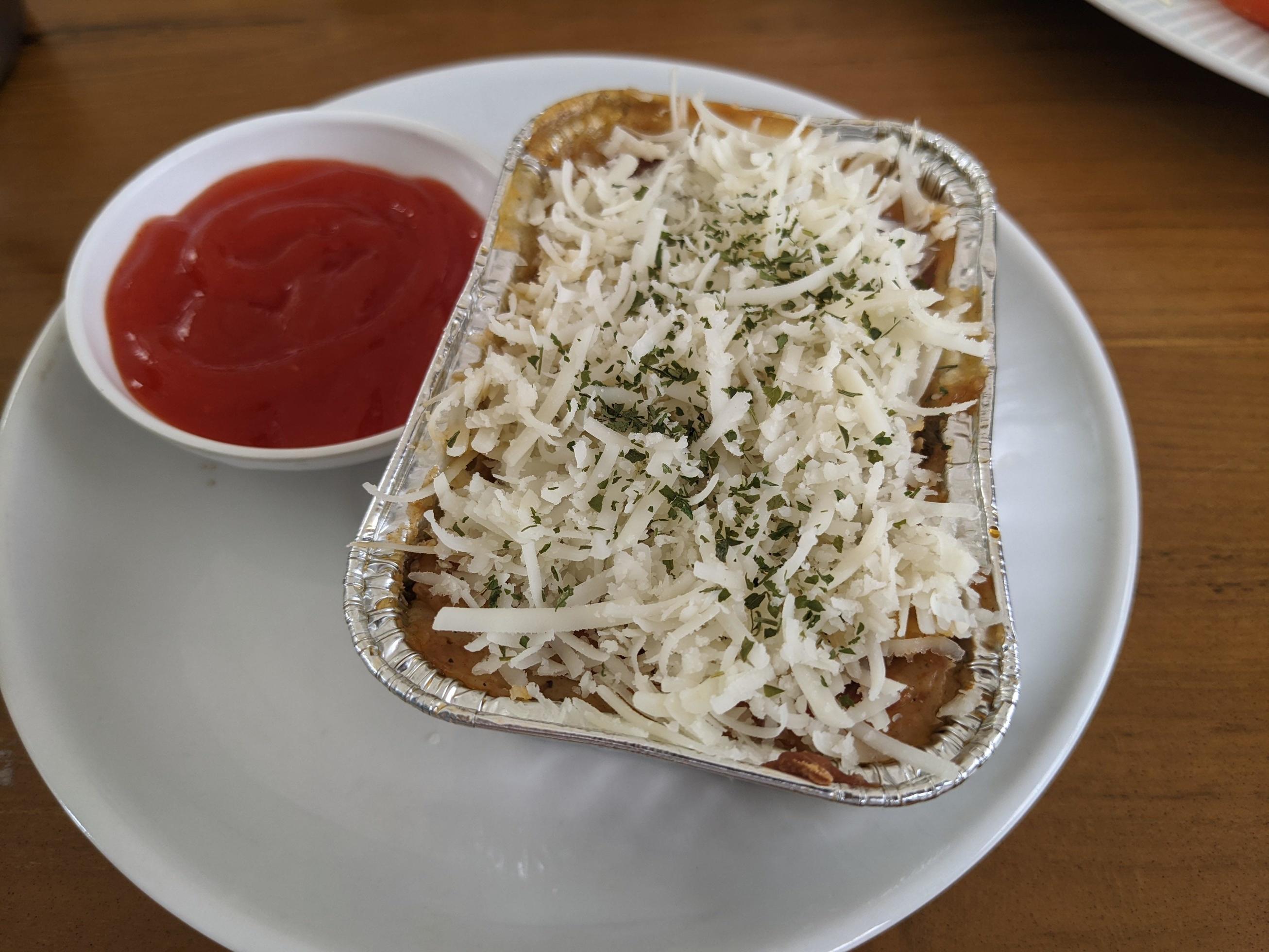 Cedar Cheese and mozzarella on the roasted beef lasagna with chili sauce. The photo is suitable to use for food background, poster and food content media. Stock Free