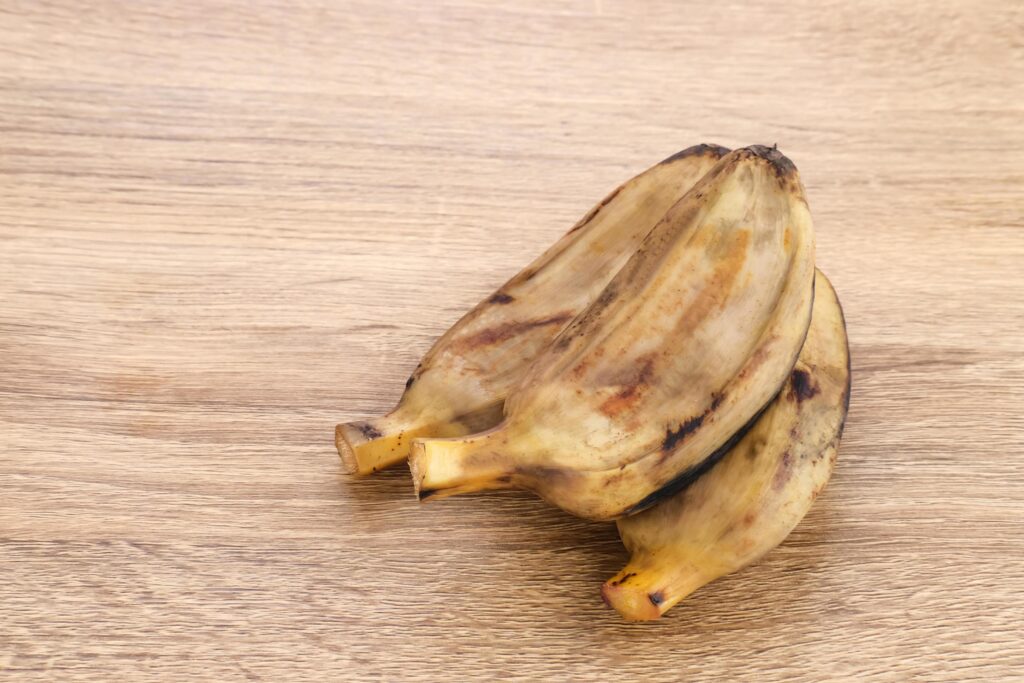 Pisang Kukus or Steamed Banana, Indonesian traditional food, a healthy snack. Served on wooden table. Close up. Stock Free