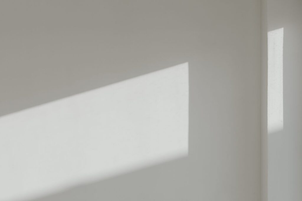 Sunlight on a white wall – minimalist wallpaper – background Stock Free