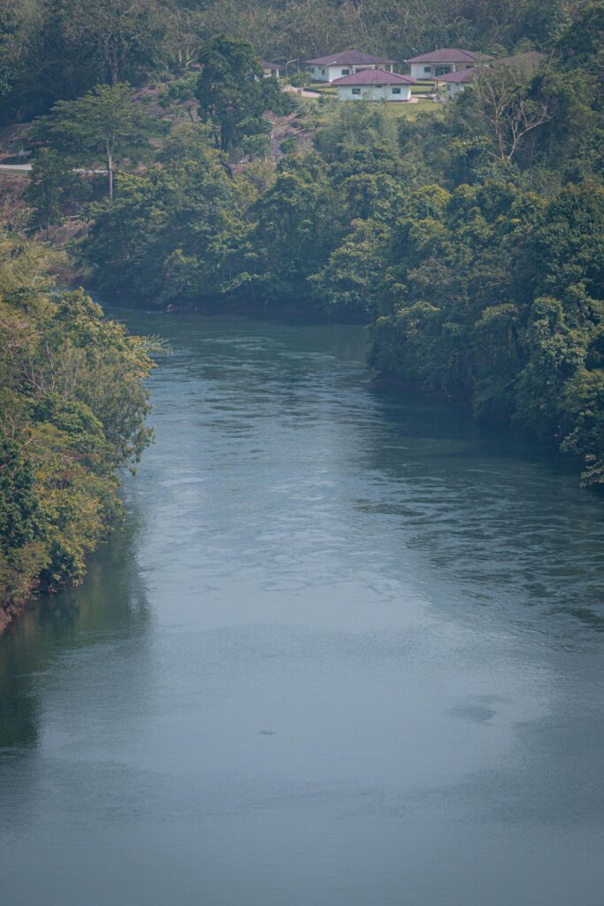 An aerial view of the dam-caused canal in Thailand’s national park, with a mountain the background. Bird eye view. Stock Free