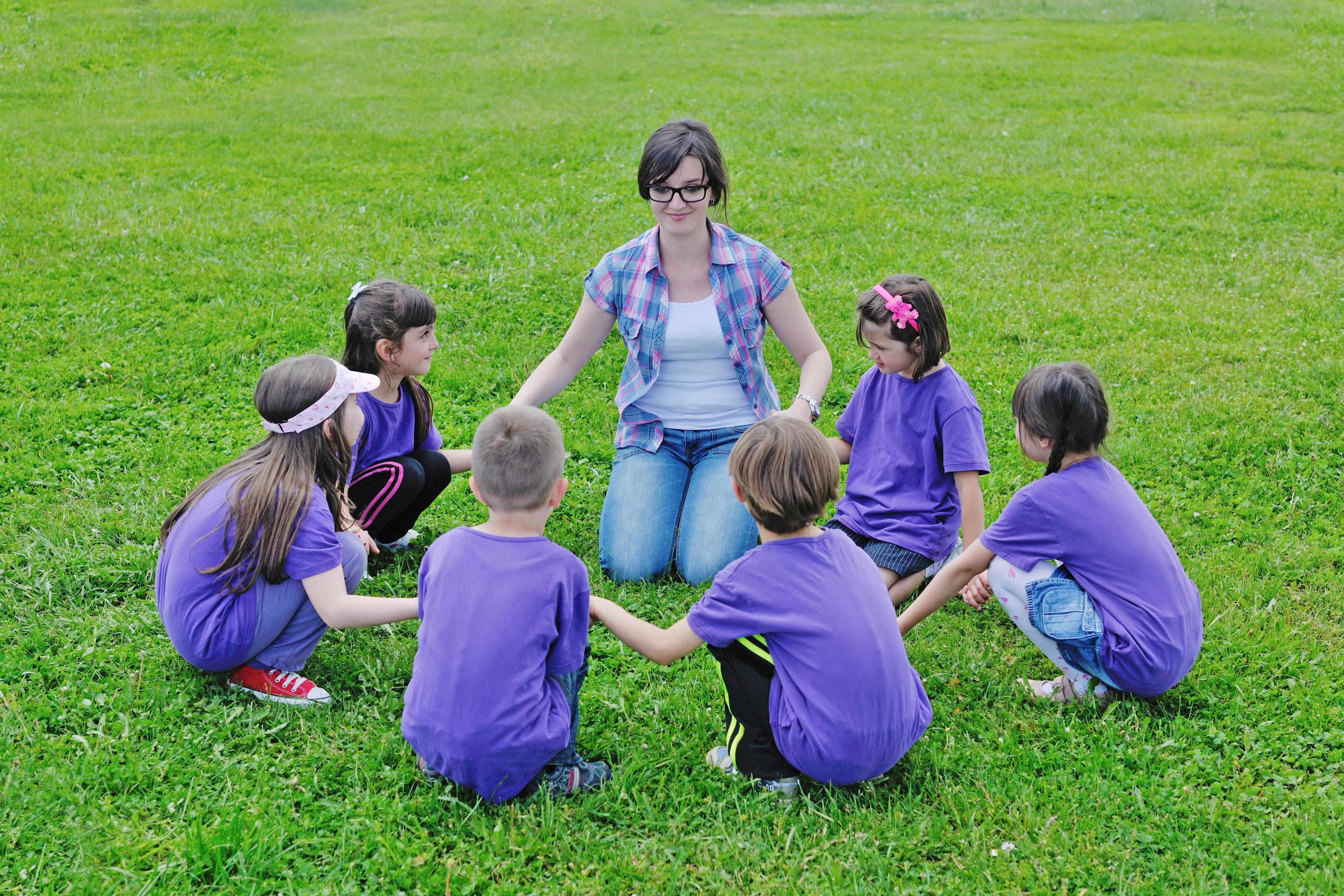 happy kids group with teacher in nature Stock Free