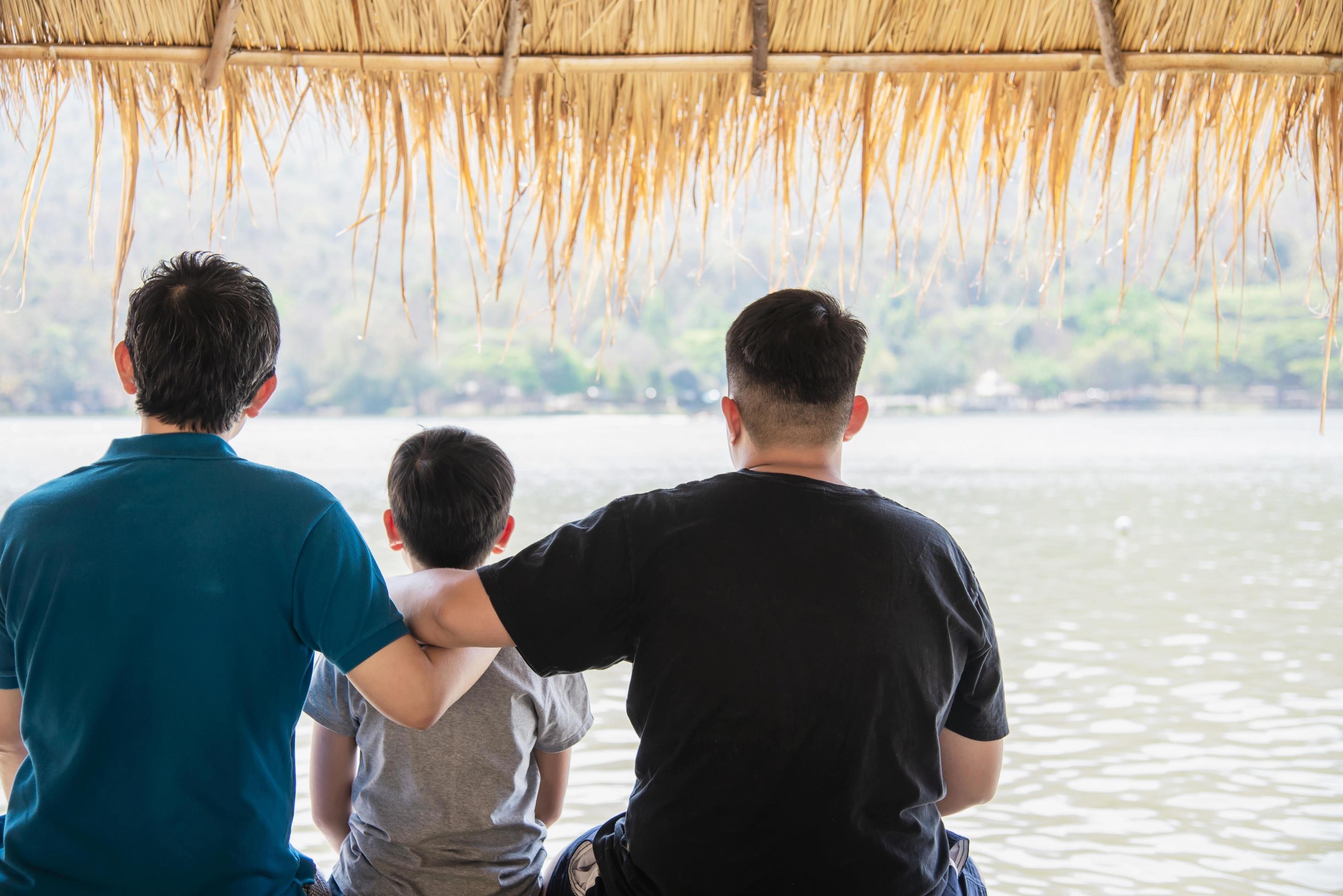 Happy dad and son during vacation at water site nature – happy family vacation concept Stock Free