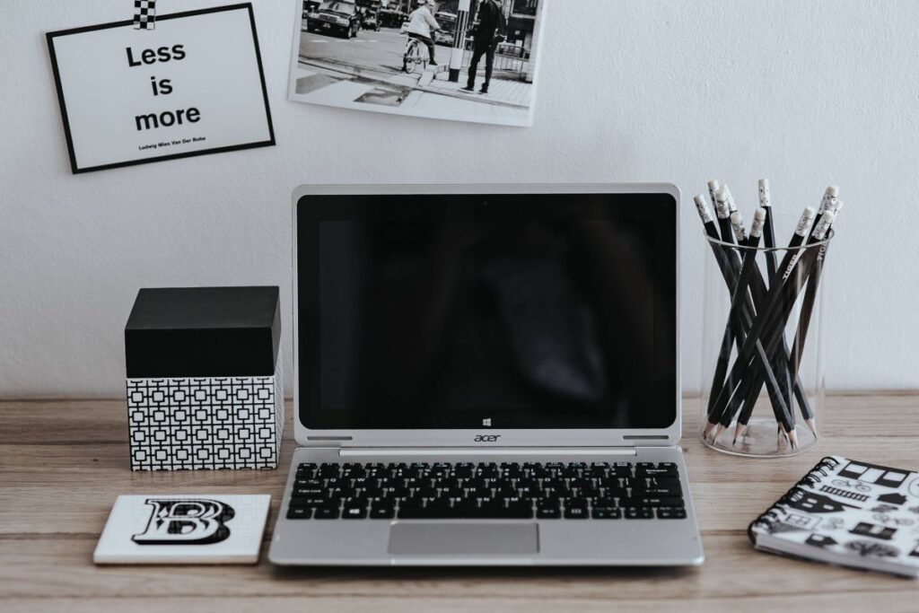 Inspirational cards with quotes, a black-and-white photo and a silver laptop Stock Free