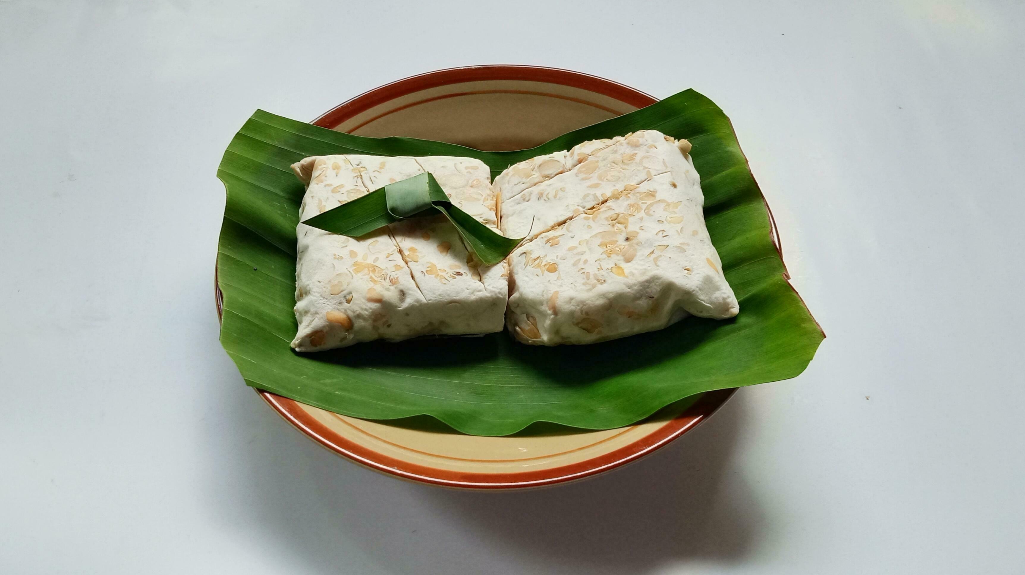 Raw Tempeh, Tempeh or Tempe on banana leaves, Indonesian traditional food, made from fermented soybeans. close up. Stock Free