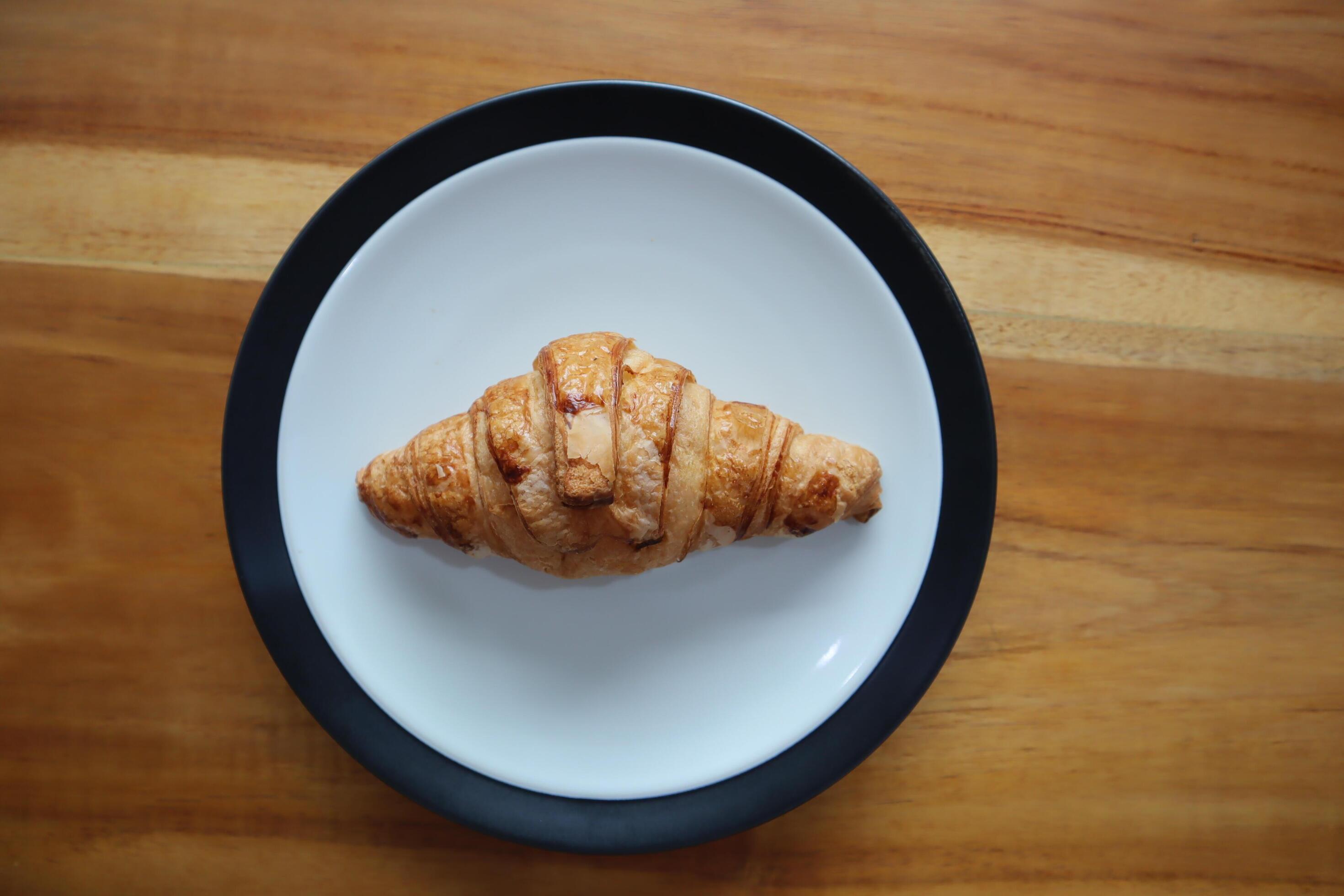 A plate of smoked beef croissants on the table background Stock Free