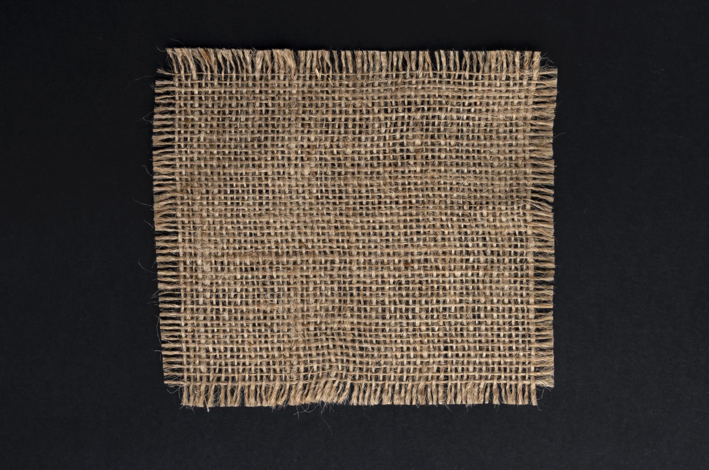 
									Old burlap fabric napkin on black background, top view Stock Free