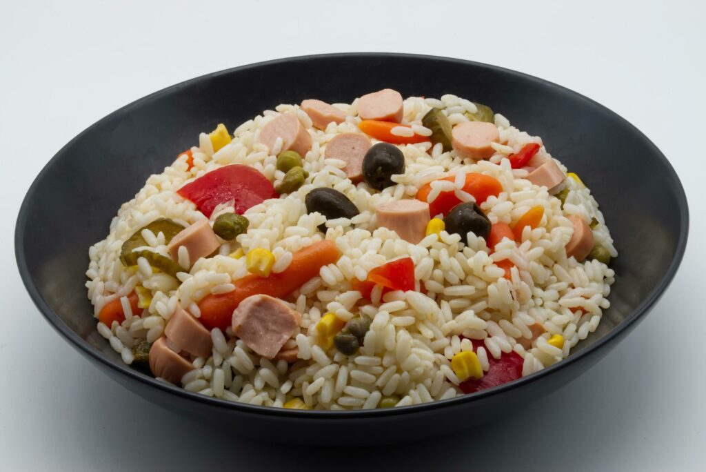 Cold rice salad. Concept of healthy summer food. Stock Free