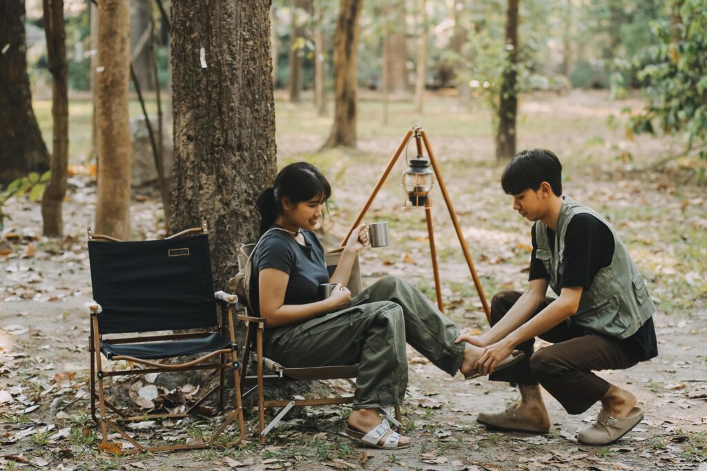 Asian couple sweet in tent inside on they camping trip, traveller relax and sleep togather in out door and camping trip Stock Free